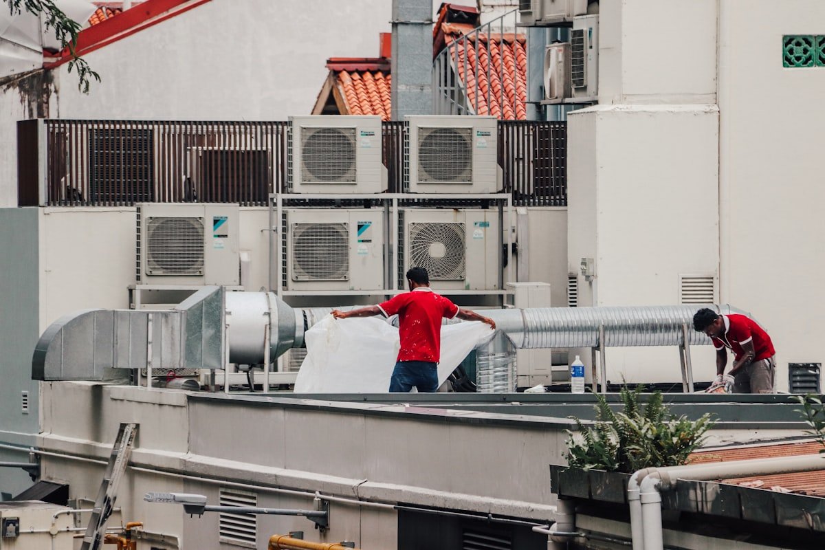 HVAC technicians working on rooftop AC unit in Canoga Park